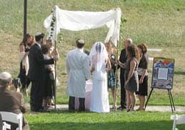 Title: Bride and groom stand in front of the chupah, with the ketubah displayed on the right Source: http://www.flickr.com/photos/goldberg/1134330696/in/photostream/