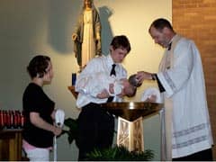 Priest baptizes an infant using holy water Source: http://www.flickr.com/photos/jerhoyet/3497586103/
