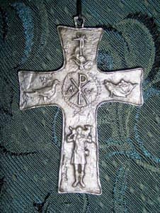 Source: http://www.flickr.com/photos/francisteresa/2316679650/ Title: a cross with various symbols of Christ: the lamb, the fish, alpha and omega, and the XP logo