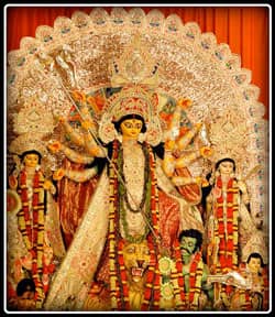 Durga, standing on her lion, stabs Mahishasura
