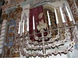 http://www.flickr.com/photos/emmanueldyan/181682881/ Title: Synagogue in Poland, depicting the menorah in front of the Holy Ark